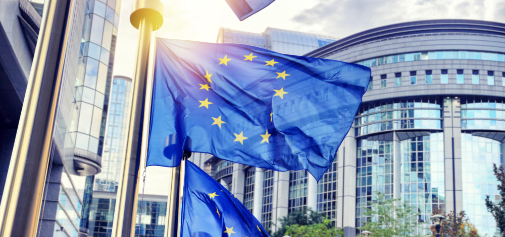 EU flags waving in front of European Parliament building in Brus
